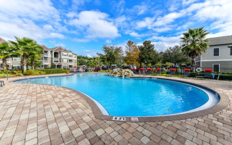 a pool with a stone patio