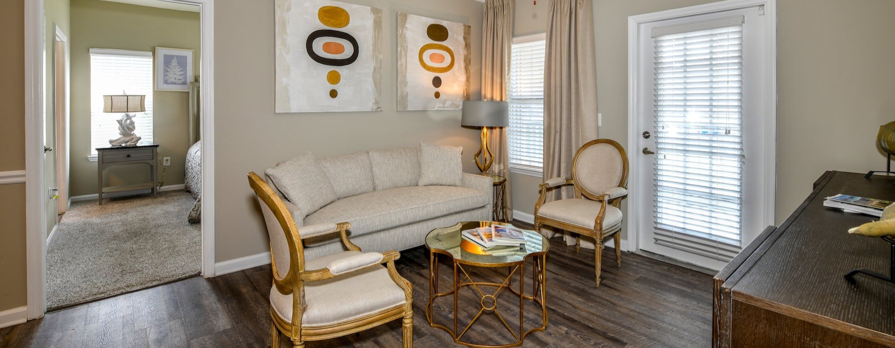 a living room with a couch and chairs