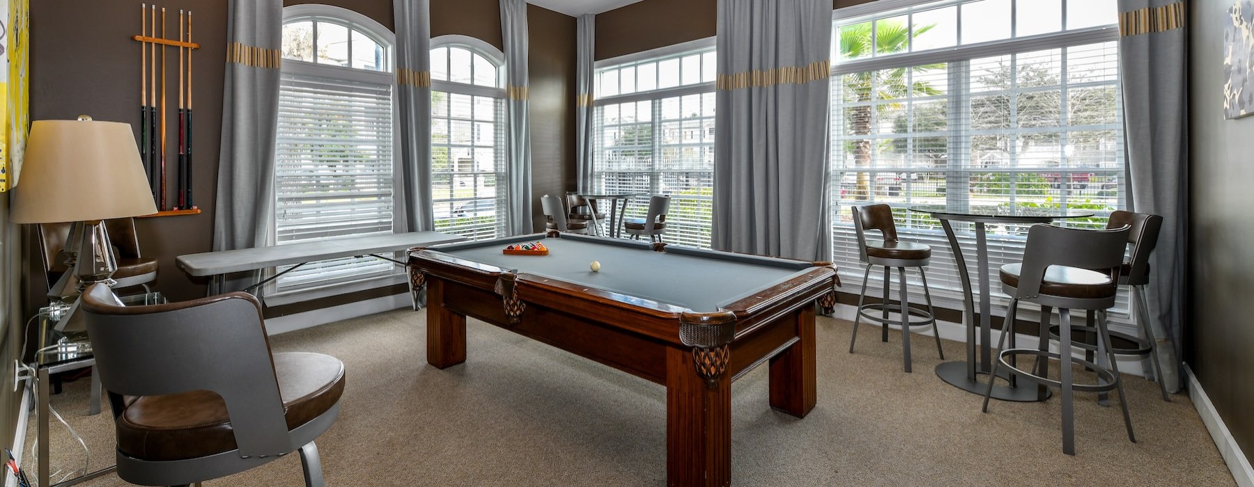 a clubroom with a pool table and chairs