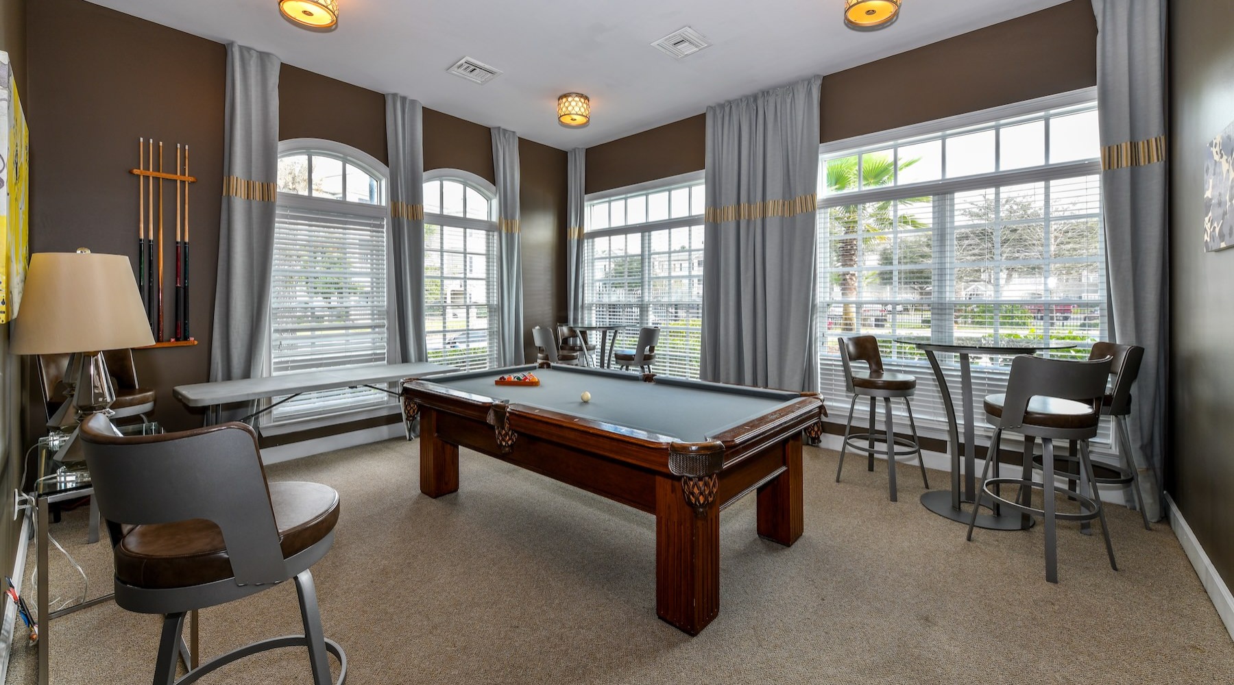 a clubroom with a pool table and chairs