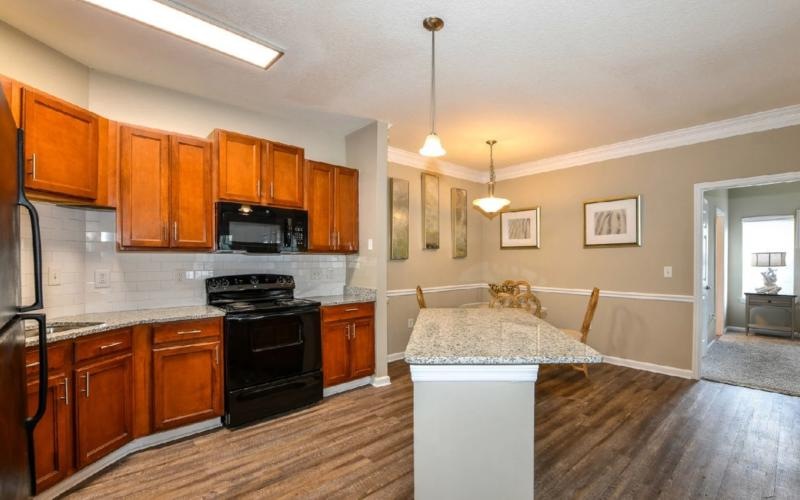 a kitchen with wooden cabinets